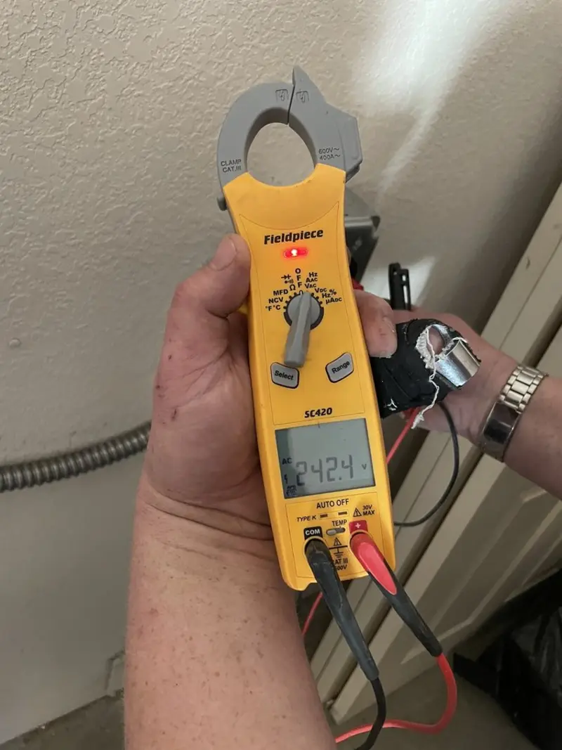 Voltage testing with clamp meter during Recessed Lighting Installation in St. Augusta